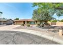 Attractive single-story home with a tidy front yard, desert landscaping, attached two-car garage and tile roof at 8532 E San Bruno Dr, Scottsdale, AZ 85258