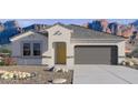 New single-story home with a gray roof, desert landscaping, and mountain views in the background at 8534 W Gehrig Way, Florence, AZ 85132