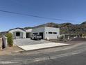 Contemporary home featuring a white stucco exterior, mountain views, and concrete driveway at 9027 S 19Th St, Phoenix, AZ 85042