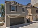 Exterior view of the two-car garage with an alleyway entrance, showcasing the home's architecture at 9233 E Neville Ave # 1011, Mesa, AZ 85209