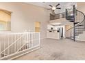Spacious living area with spiral staircase and loft overlooking modern kitchen at 9233 E Neville Ave # 1127, Mesa, AZ 85209