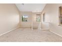 Bright, open living room with neutral walls and plush carpeting at 9233 E Neville Ave # 1127, Mesa, AZ 85209