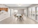 Open-concept dining room area featuring tile flooring and ample natural light from patio doors at 10330 W Thunderbird Blvd # B112, Sun City, AZ 85351