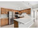 Bright kitchen featuring stainless steel appliances, white countertops and oak cabinetry at 10330 W Thunderbird Blvd # B112, Sun City, AZ 85351