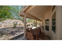 Covered patio with dining set, offering scenic backyard desert views at 116 E Mountain Sky Ave, Phoenix, AZ 85048