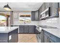 Kitchen features stainless steel appliances, sleek countertops and plenty of natural light at 11952 W Villa Chula Ln, Sun City, AZ 85373