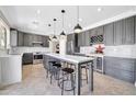 Spacious kitchen featuring an island with seating, modern appliances, and ample cabinet space at 11952 W Villa Chula Ln, Sun City, AZ 85373