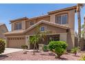 Two-story home featuring desert landscaping, tile roof, and a two-car garage at 12274 W Monroe St, Avondale, AZ 85323