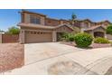 Exterior shot of a two story home with desert landscaping and a two car garage at 12274 W Monroe St, Avondale, AZ 85323