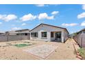 The home's backyard includes desert landscaping, a brick patio, and a covered porch at 12375 W Whyman Ave, Avondale, AZ 85323