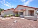 Charming home with a red tile roof and desert landscape, offering a warm welcome at 12641 S 39Th Pl, Phoenix, AZ 85044