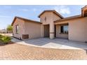 Charming single-story home with neutral stucco exterior, concrete driveway and neat landscaping at 20310 W Hubbard Rd, Buckeye, AZ 85326