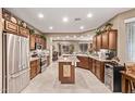 Modern kitchen with stainless steel appliances, stone countertops, and ample cabinet space at 28878 N 127Th Ln, Peoria, AZ 85383