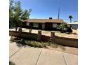 Charming single-story home with updated windows and a unique brick and stone wall at 3211 W Campbell Ave, Phoenix, AZ 85017
