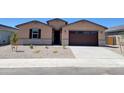Charming single-story home with a well-maintained gravel front yard and a two-car garage at 37131 W Parador Ln, Maricopa, AZ 85138