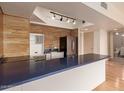 Modern kitchen with stylish blue countertops, stainless steel refrigerator, and decorative backsplash at 4750 N Central Ave # N7, Phoenix, AZ 85012