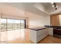 Bright living room with hardwood floors, large windows, and great views of the city and mountains at 4750 N Central Ave # N7, Phoenix, AZ 85012