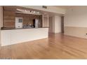 Open floor plan featuring a modern kitchen area, hardwood floors, and neutral wall colors at 4750 N Central Ave # N7, Phoenix, AZ 85012