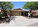Attractive single-Gathering home with mature trees, a two-car garage, and desert landscaping in front at 5130 W Molly Ln, Phoenix, AZ 85083