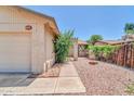 Charming single-story home featuring a low-maintenance rock front yard and walkway leading to the entrance at 5237 W Mountain View Rd, Glendale, AZ 85302