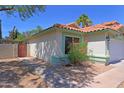 A well-kept single-story home with a terracotta roof, tidy landscaping, and a private side entrance at 5902 E Juniper Ave, Scottsdale, AZ 85254