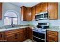 Fully equipped kitchen with stainless steel appliances and granite countertops at 5902 E Juniper Ave, Scottsdale, AZ 85254