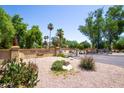 Welcome to The Villages Casas! A lovely gated community entrance with mature landscaping at 851 E Village Circle N Dr, Phoenix, AZ 85022