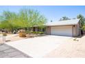 A single-story home featuring drought-resistant landscaping, a walkway, and two car garage at 851 E Village Circle N Dr, Phoenix, AZ 85022