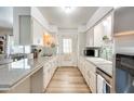 Functional kitchen with white cabinetry, sleek countertops, and modern appliances at 856 N Evergreen St, Chandler, AZ 85225