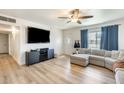 Inviting living room featuring wood flooring, a ceiling fan, and a comfortable sectional couch at 856 N Evergreen St, Chandler, AZ 85225