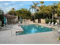 Community pool with deck chairs and desert trees in background on sunny day at 9070 E Gary Rd # 152, Scottsdale, AZ 85260
