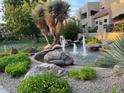 Scenic community water feature with boulders, water fountain and lush desert foliage at 9070 E Gary Rd # 152, Scottsdale, AZ 85260
