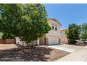 Charming two-story home with a well-maintained lawn and a spacious two car garage at 9133 W Virginia Ave, Phoenix, AZ 85037
