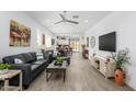 Spacious living room with modern decor, wood tile floors, and natural light at 9238 W Roma Ave, Phoenix, AZ 85037