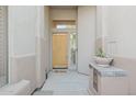 Entryway featuring a light wood door, tiled accents, and a 'Welcome' mat at 11299 E Greythorn Dr, Scottsdale, AZ 85262
