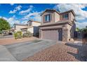 Charming home with a well-maintained driveway, landscaping with stone accents and lush trees at 11383 W Pima St, Avondale, AZ 85323