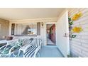 Cozy front porch with comfortable seating, decorative accents, and a welcoming entrance at 1710 W 13Th Ave, Apache Junction, AZ 85120