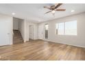 Bright living room with wood flooring, staircase and a large window offering natural light at 222 W Brown Rd # 14, Mesa, AZ 85201