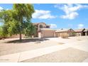 Two-story home with tan exterior, desert landscaping, driveway, and tile roof at 2605 W Darrel Rd, Phoenix, AZ 85041