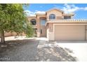 Home exterior with two stories, desert landscaping, tile roof, and a two-car garage at 2605 W Darrel Rd, Phoenix, AZ 85041