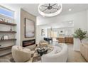 Inviting living room features a fireplace, modern lighting, and open access to the dining area and kitchen at 2949 N 29Th St, Phoenix, AZ 85016