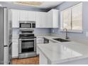 Modern kitchen with stainless steel appliances, white cabinets and quartz countertops at 2954 N Oregon St # 6, Chandler, AZ 85225