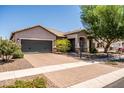 Well-maintained single-story home featuring a desert landscape, a two-car garage, and a paved driveway at 3022 E Santa Fe Ln, Gilbert, AZ 85297