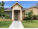 Inviting front porch with classic columns and detailed archway, with a well-kept lawn and mature plants at 3116 W Dailey St, Phoenix, AZ 85053
