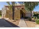 Exterior of condo building with desert landscaping and a wooden awning at 3434 E Baseline Rd # 126, Phoenix, AZ 85042
