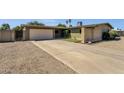 Inviting single-level home with a spacious driveway and well-kept front yard landscaping at 3537 W Shangri La Rd, Phoenix, AZ 85029