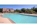 Community pool with lounge chairs, umbrellas, and well-maintained grounds at 3935 E Rough Rider Rd # 1101, Phoenix, AZ 85050