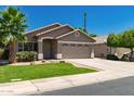 Single-story home with a two-car garage, desert landscaping, and a neatly kept lawn under a clear sky at 3940 E Heather Ct, Gilbert, AZ 85234