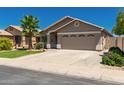 Charming single-story home with a two-car garage, desert landscaping, and a spacious driveway at 3940 E Heather Ct, Gilbert, AZ 85234