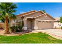 Inviting single-story home with a manicured lawn, desert landscaping, and a convenient two-car garage at 3940 E Heather Ct, Gilbert, AZ 85234